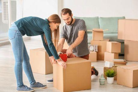 An image of a couple unpacking their stuff to move out after apply for a mortgage.