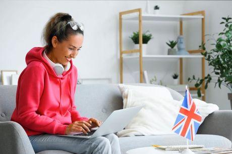 A woman sitting at her home in front of her laptop checking if she's on the electoral roll in the UK.