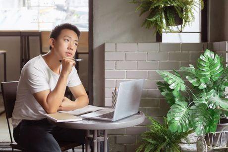 A young man in front of his laptop wondering if a Notice of Correction will help his credit report.