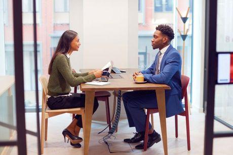 A young immigrant man interviewing after proving his right to work in the UK.