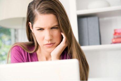 A woman looking at her laptop searching if ClearScore is accurate.