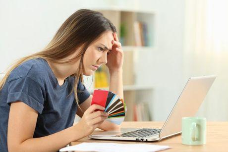 A picture of a woman holding her multiple cards from opening multiple bank accounts.