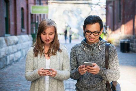 An image of two people looking at their phone searching for Equifax and Experian.