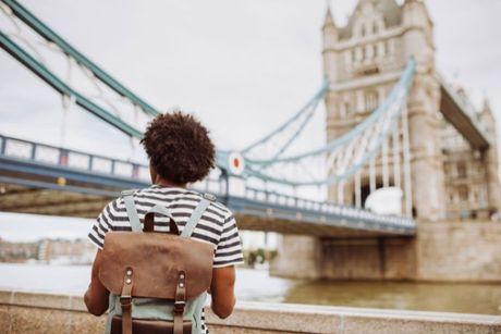 A young man facing the London Bridge and wondering about how he can prove his right to live in the UK.