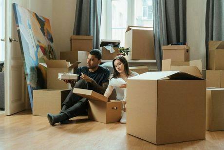 A couple unpacking their stuff after moving in into their new house with a 95% mortgages in the UK.