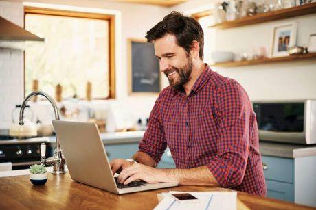 An image of a man with his laptop feeling happy after knowing he had a Very Good credit score.