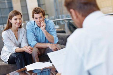 A couple sitting with a lender with document in their hand, asking for a chances of approval for a loan.