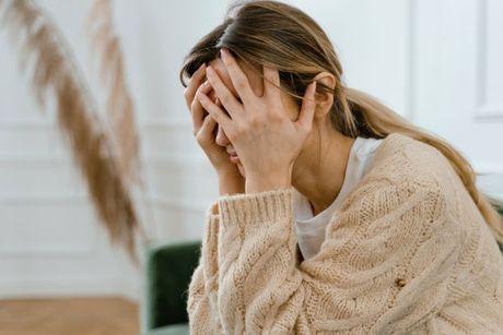 A girl looking very worried and stressed after she got a late payment fee.