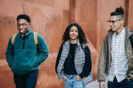 A group of friends walking together and discussing about loans for credit building.