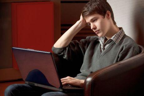 an image of a guy looking at his laptop and waiting for his credit check 