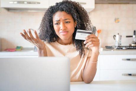 An image of young woman in front of her laptop looking disappointed after Opus credit card has shut down.