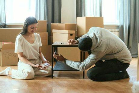 A couple sitting down in their house with a new furniture after they get the furniture on finance with no credit check.