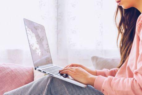 An image of young woman in front of her laptop adding a notice of correction with Credit Karma.