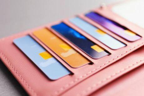 An image of pink card holder with multiple balance transfer credit card in it.