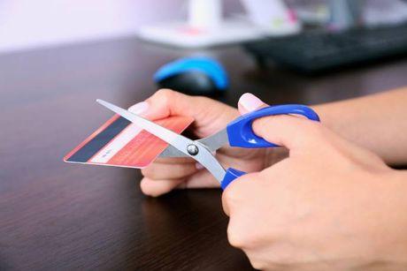 An image of someone cutting a credit card because she doesn't use it anymore.