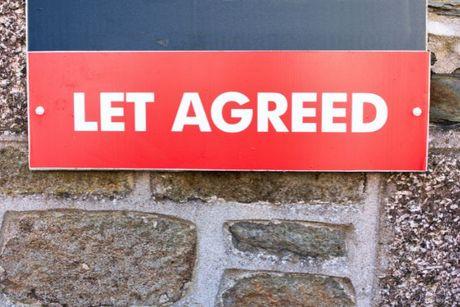 "Let agreed" sign on a property wall.