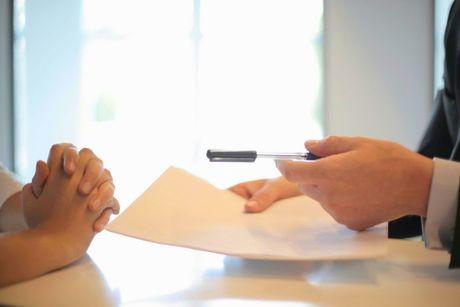 A picture of someone receiving a mortgage in principle document from Barclays.