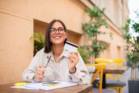 A woman looking very happy after she got her 0% interest credit card.