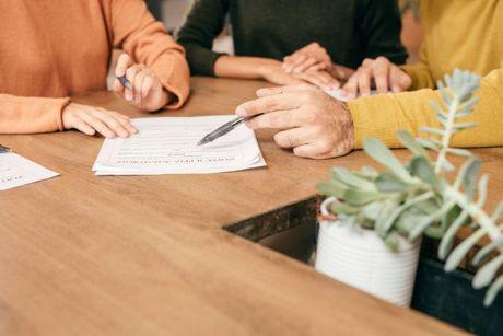 Self-employed couple signing a mortgage application form and inquiring what happens if they don't have an SA302 form.