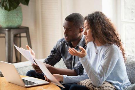 A couple looking at their documents discussing if debt consolidation worth it.