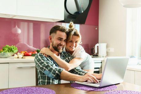 A woman hugged her husband happily while looking at their laptop, feeling happy after checking credit score with experian.