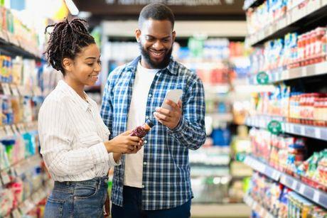 A woman and her friend buying some stuff at Tesco and paying it with Tesco Foundation Credit Card.