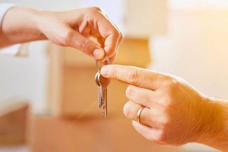An image of someone passing the key to another person for a mortgage.