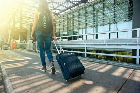 An image of an immigrant with her luggage just move to the UK. 