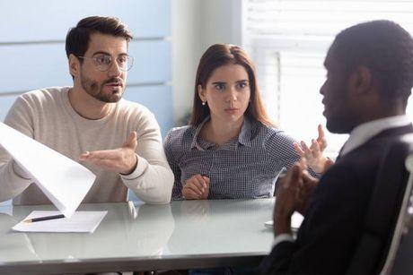 A couple asking a banker why their loan approved in principle got declined.