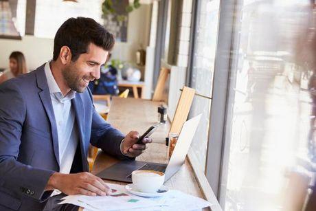 A man in front of his laptop doing some work and sharing his Experian credit report.