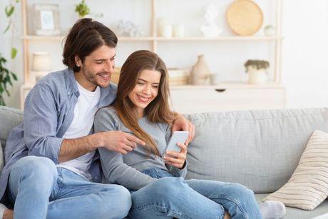 A couple got married and looking at their credit score on a phone.