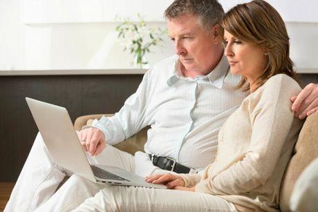 A woman and her husband in front of her laptop searching if Experian is safe.