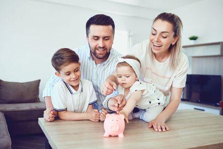 A picture of a family teaching their kids to saving their money into a piggy bank.