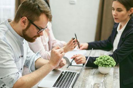 A couple and a mortgage broker discussing about getting a joint mortgage with one spouse unemployed.