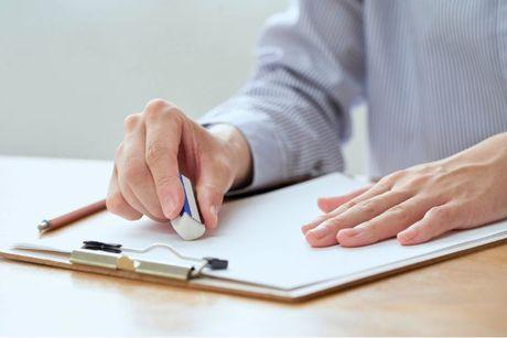 An image of a person erasing an error information on his paper.