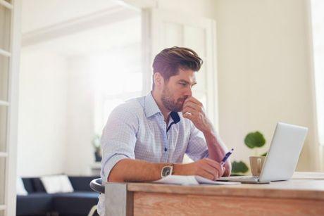 A man looked confused in front of his laptop searching about how a notice of correction works.