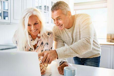 An image of old couple looking at their laptop trying to figure out how Experian CreditExpert works.