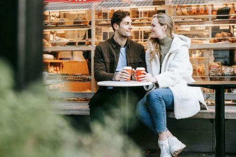 A couple in front of a coffee shop discussing about their joint account and credit rating.