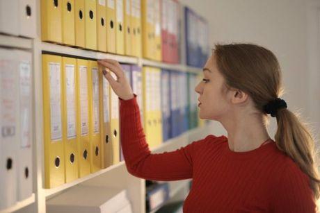 An image of a woman looking at her credit file documents.