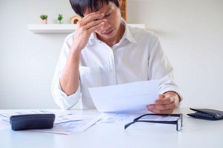 Man holding a paper copy of his credit report showing a CIFAS marker.