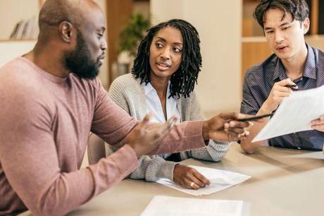 A couple with a mortgage broker discussing about their application after an arranged overdraft.