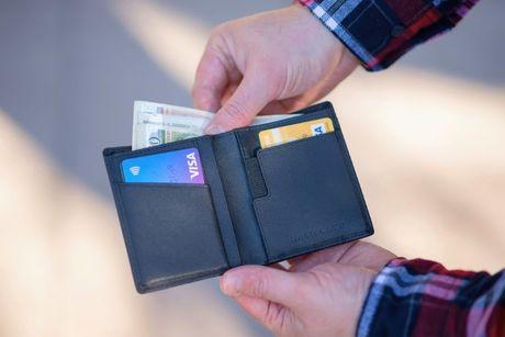 A picture of a wallet with banknotes and credit cards.