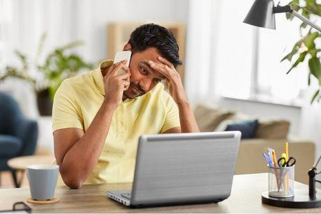 A man looked confused looking at his laptop and trying to figure out how to correct wrong ClearScore report information. 